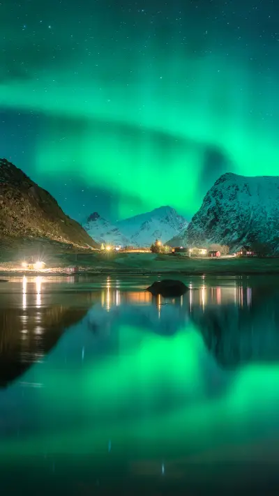 Aurora borealis, snowy mountains, fjord and reflection