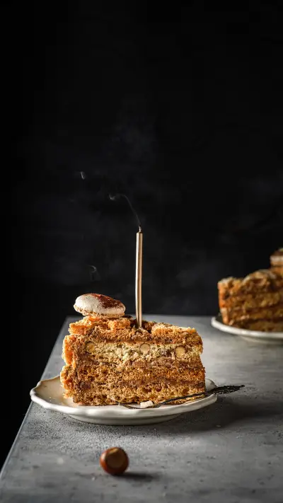 Meringue cake with hazelnuts and cream on a dark background - Screenshot 1