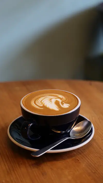 Coffee latte art on the wood desk in coffee shop cafe