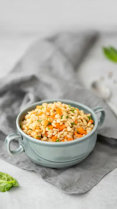 Boiled barley porridge with vegetables and spices in a plate