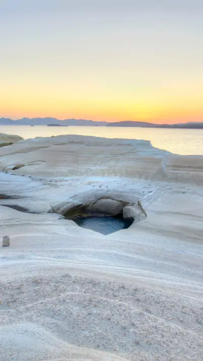 The white cliffs of Sarakiniko Beach at sunrise