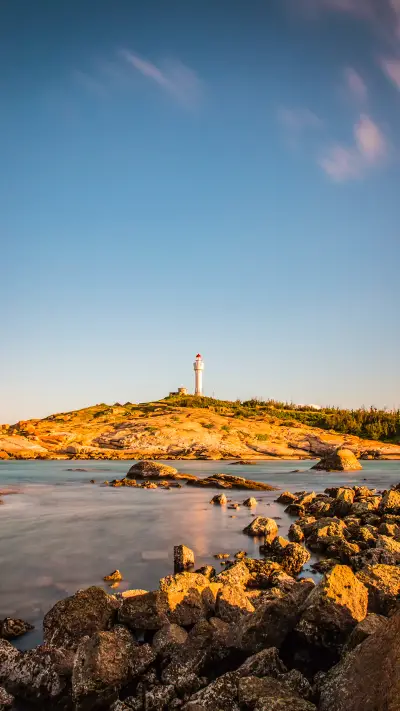 The sunset scenery of Red Bay Lighthouse Island at dusk