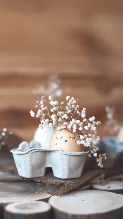An Egg with a Painted Smiling Face and Flowers