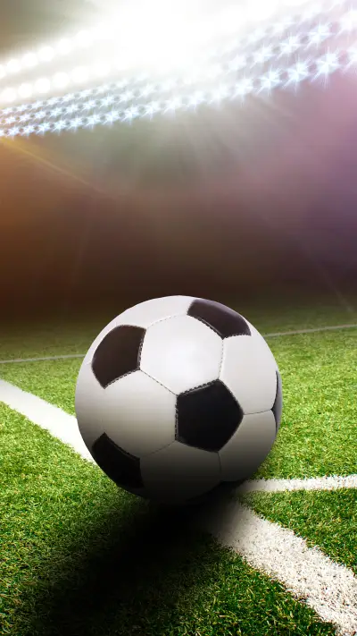 A football field corner with a black and white ball