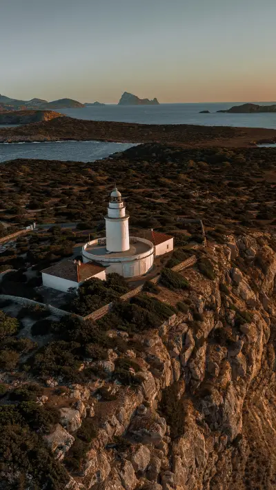 Lighthouse at sunset on cliff overlooking Mediterranean