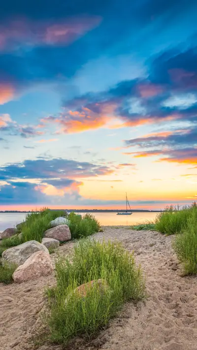 Father and son enjoying the sunset on the Baltic Sea beach