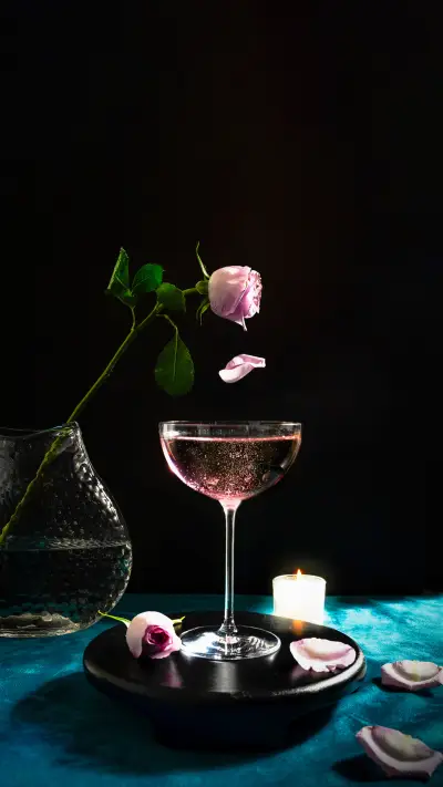 Champagne Cocktails with Pink Rose and a Candle