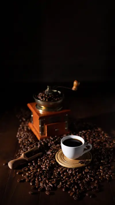 Cup of coffee and beans on wooden table
