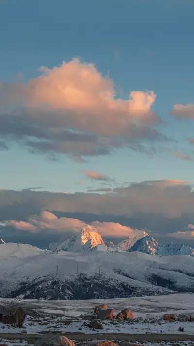 The snow capped mountains illuminated by sunlight