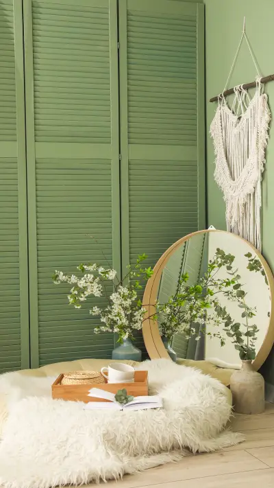 Cozy Place for Rest with Mirror and Blooming Tree Branches