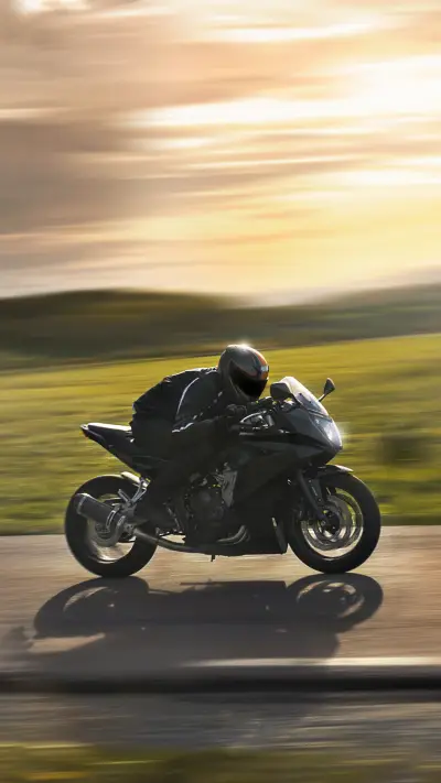 Man Riding a Sports Motorbike at Sunset