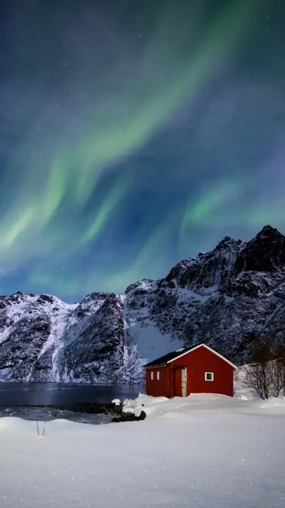 Red Cabin Under Aurora's Glow